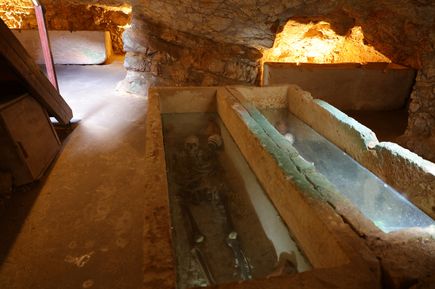 Steinsarg mit Skelett und Grabbeigaben in der Nekropole von Puig des Molins auf Ibiza