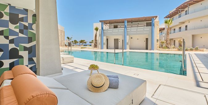 Exklusive Swim‑up‑Zimmer mit direktem Poolzugang und moderner Sonnenliege im Paralos Kosta Alimia Resort
